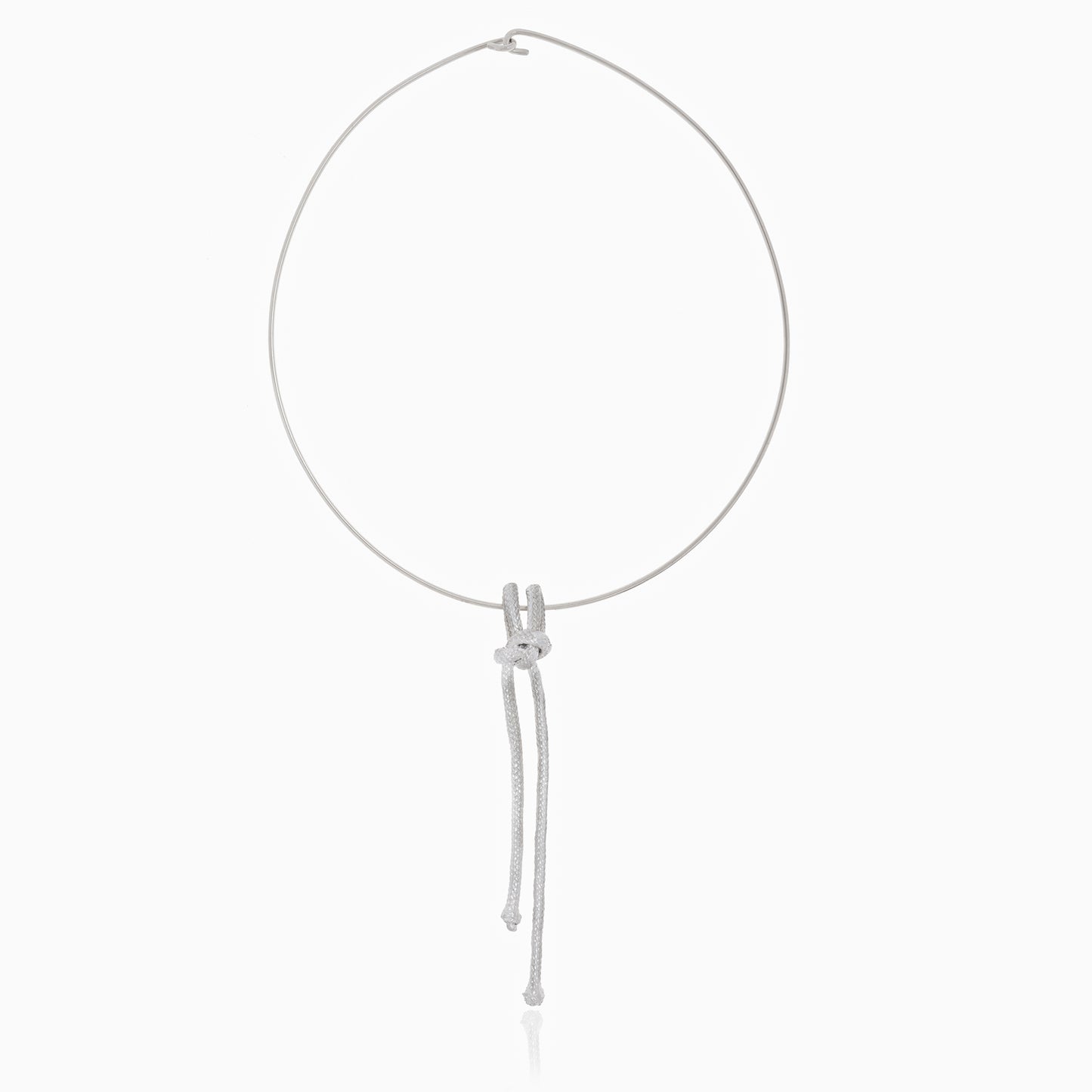 The Artisanal Made Ballestrinque Nautical Knot Pendant is a minimalistic white rope necklace that showcases a single nautical knot pendant with two loose ends elegantly hanging down.