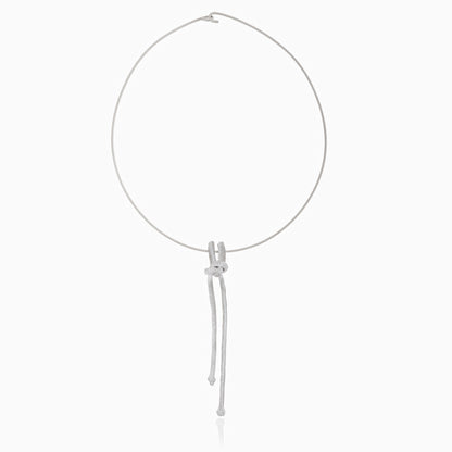 The Artisanal Made Ballestrinque Nautical Knot Pendant is a minimalistic white rope necklace that showcases a single nautical knot pendant with two loose ends elegantly hanging down.