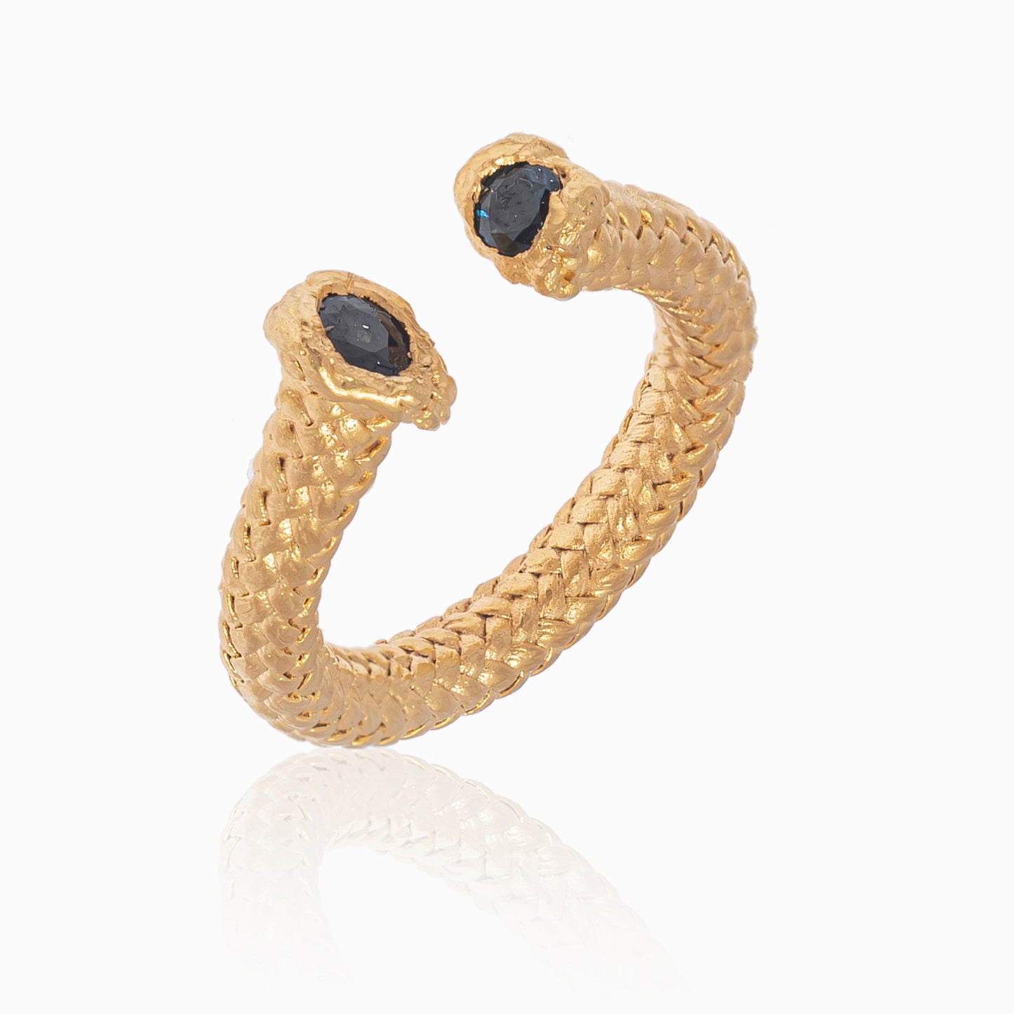 A 24k yellow gold plated open cuff ring in a braided nautical rope design, featuring two dark sapphires at each end, set against a white background.