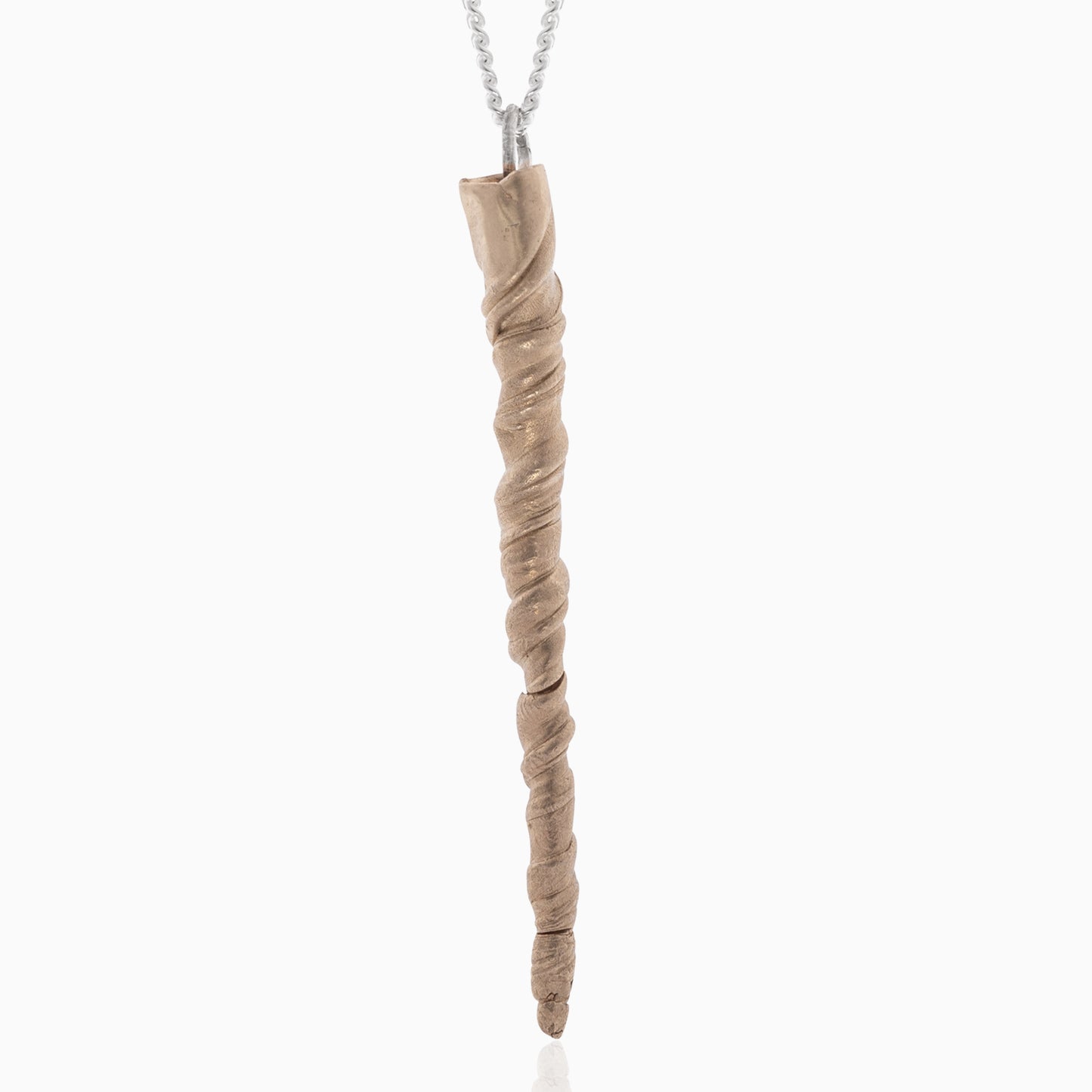 A twisted, pointed Narwhal Tusk Handmade Tooth Pendant hanging from a sterling silver necklace. The beige, textured pendant, resembling a narwhal tusk, is handmade by Angela Lago.