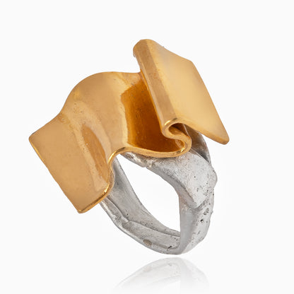 Introducing the Handcrafted Ring + Wave, a sterling silver band adorned with a 24k gold plated brass abstract, folded square top for a unique two-toned design.