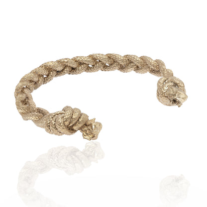 A Nautical Bracelet Torque Braid, featuring a twisted rope-style design with knotted ends, crafted from sterling silver, showcased on a white background.