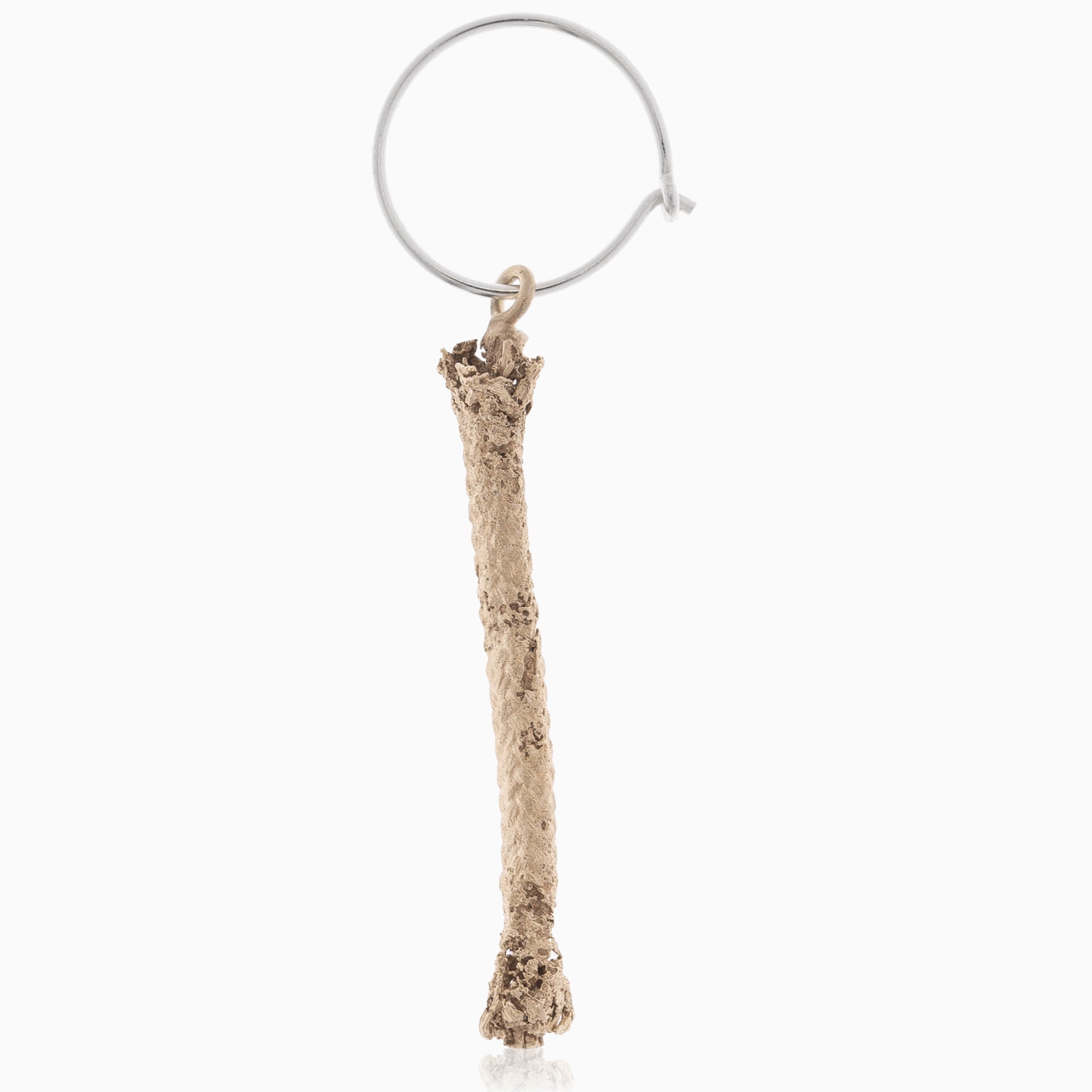 A single chicken bone attached to a Thin Hoop Nautical Earring with Sterling Silver Rope, isolated on a white background.