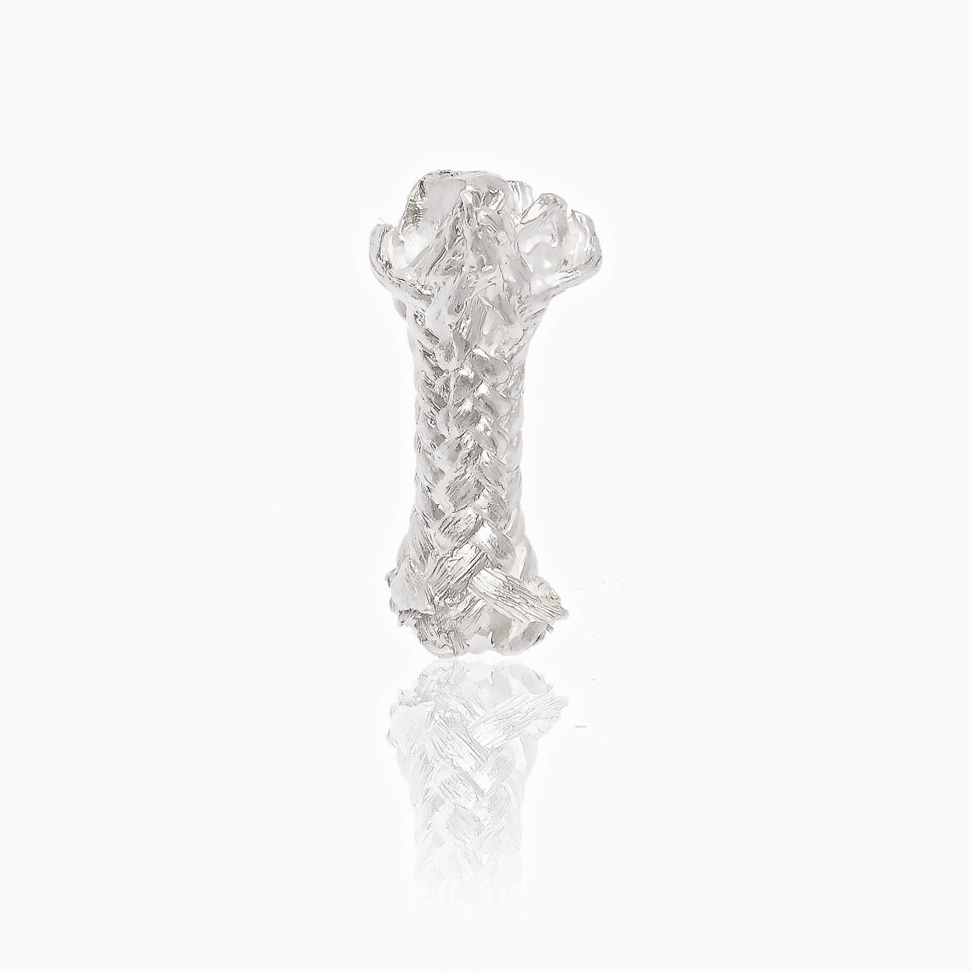 Product Description: A Sterling Silver Rope S Earring, a delicately handmade nautical jewel, stands upright on a reflective surface against a white background. This intricately designed transparent cylindrical object is adorned with exquisite details.